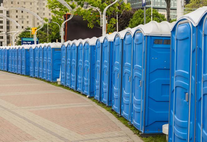 a row of portable restrooms at an outdoor special event, ready for use in Lutz